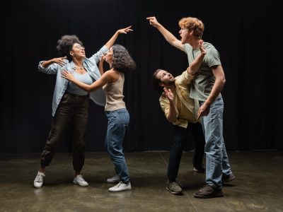 full length of young multiethnic actors posing while rehearsing in acting skills school,stock image